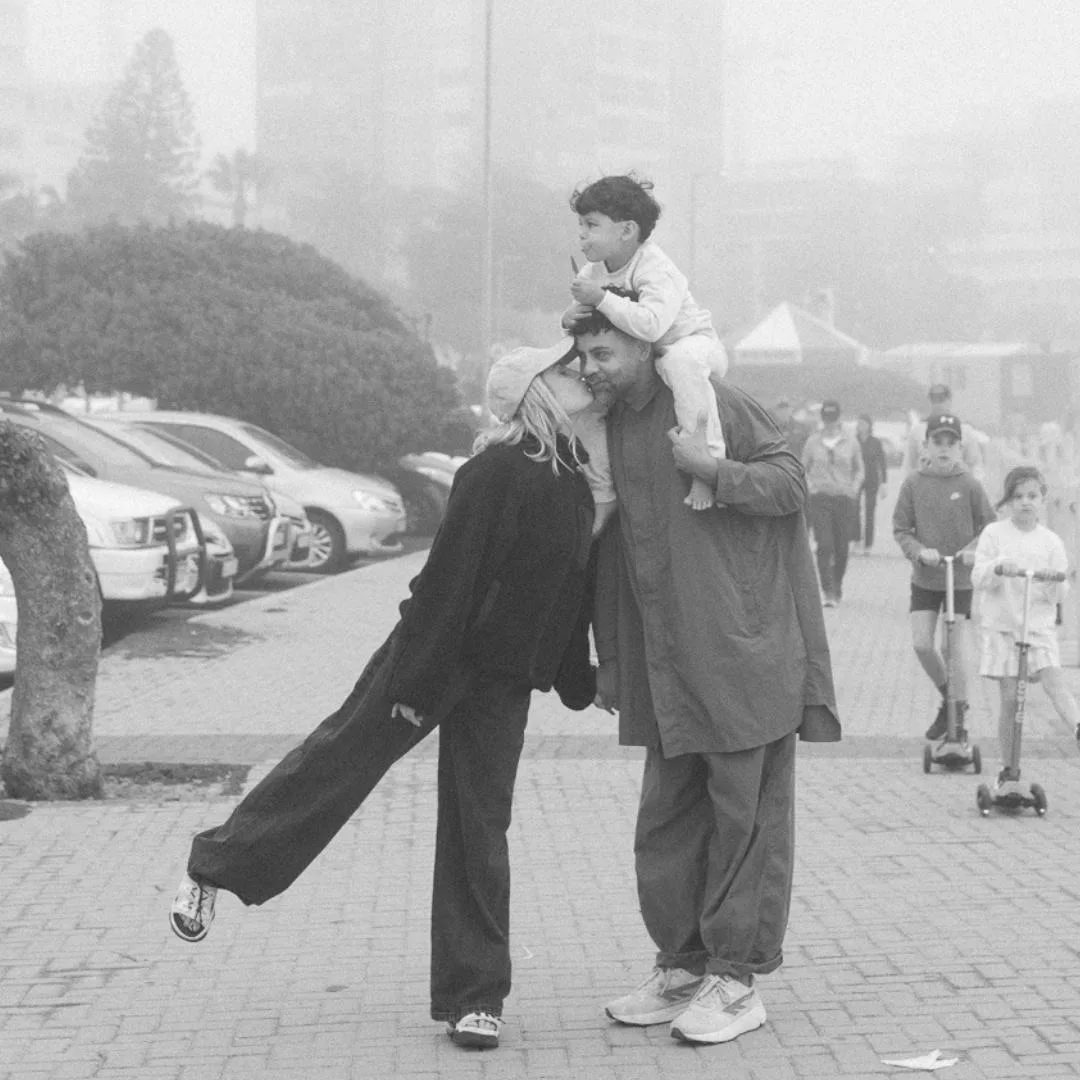 A family together on the promenade, child riding on dad’s shoulders