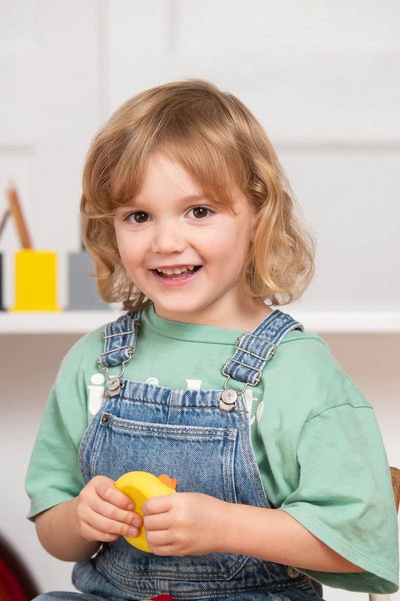 A smiling child at a school portrait session