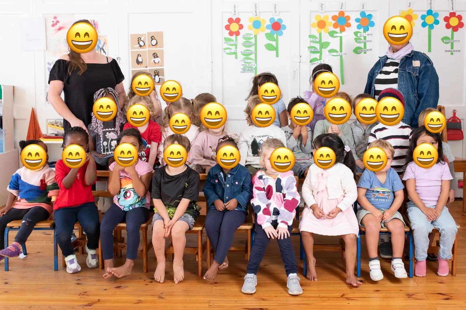 A cheerful pre-primary class with their teachers, children's faces hidden for privacy